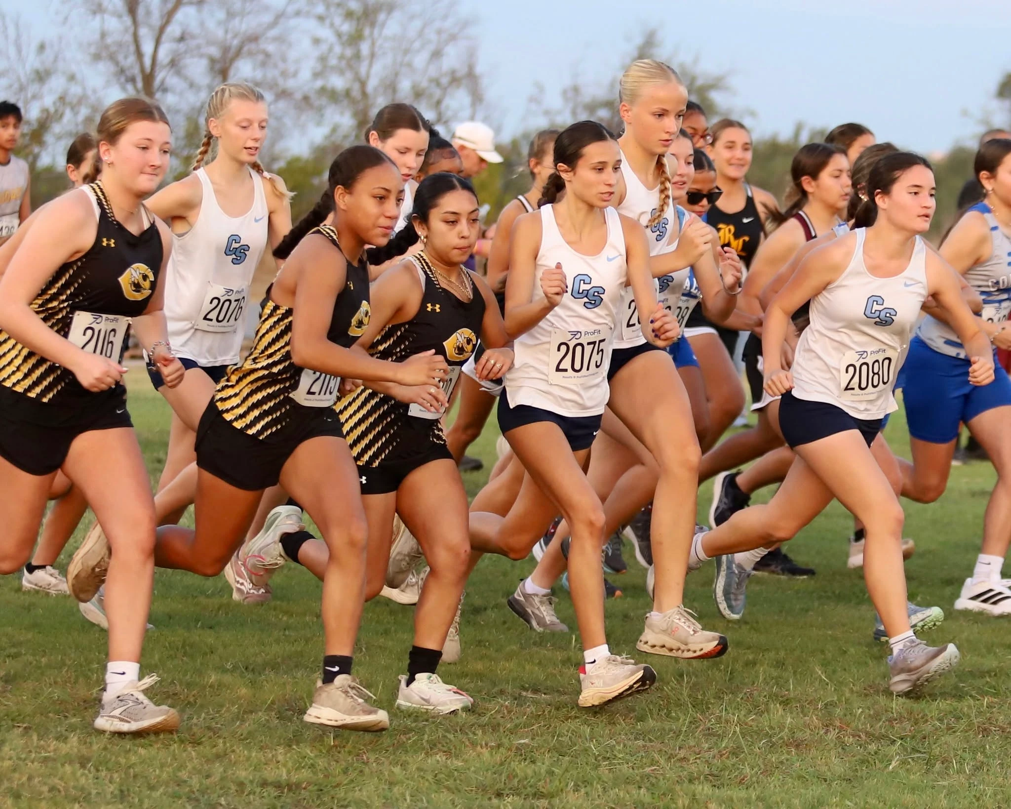 A girls cross-country field wearing Pro Fit bibs