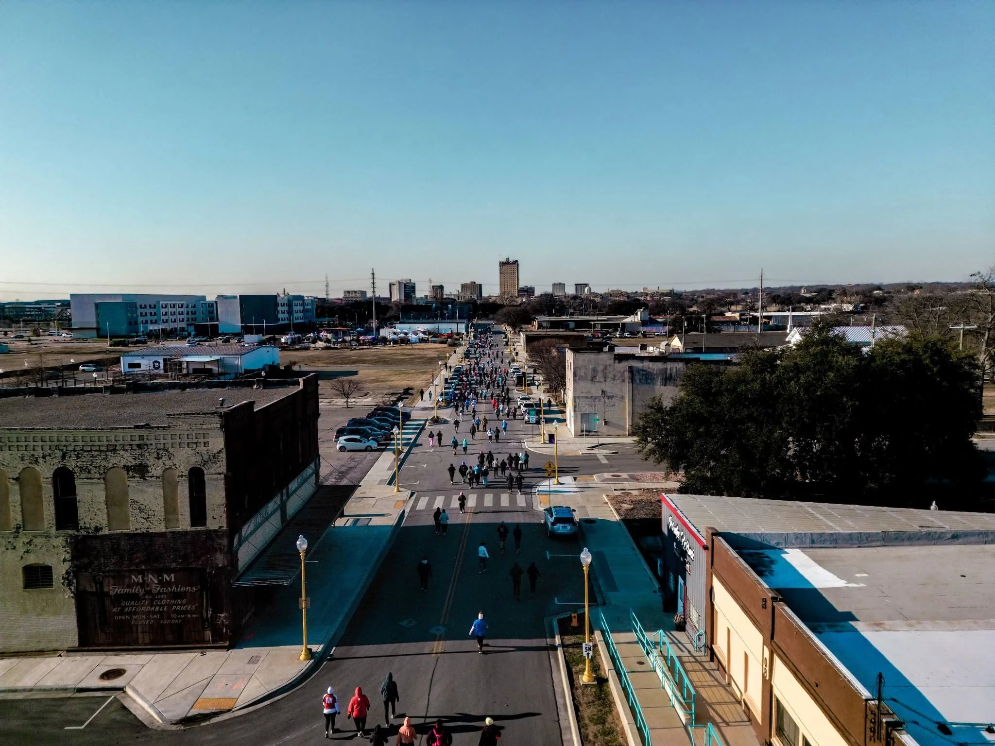 Aerial view of runners filling a downtown Waco race course